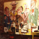 mixed media of night life and people with glasses of wine on a brick wall
